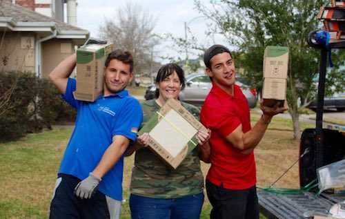 volunteers carrying tile