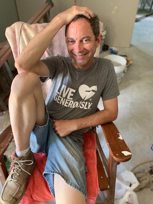 Volunteer Wil Kolnik takes a break at a home restoration worksite in New Orleans, June 2019.