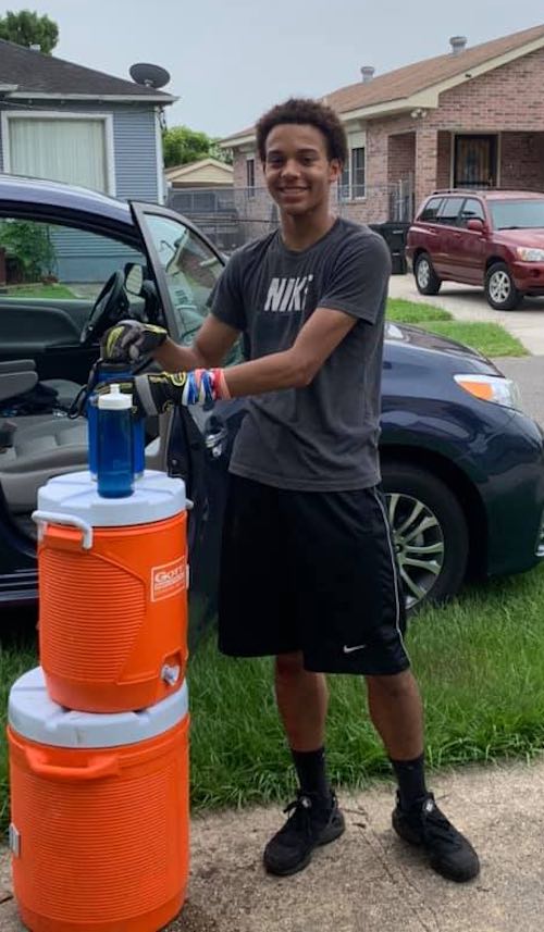 A youth volunteer stays hydrated while serving in New Orleans with Camp Restore during the summer of 2019.